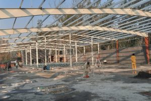 Structural steel columns and finished concrete foundation of an industrial shed by M. Siddique Sons Engineering.